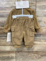 Brown toddler two-piece outfit with long sleeves and cargo pocket pants on wood background, baby clothes by Rachel Zoe