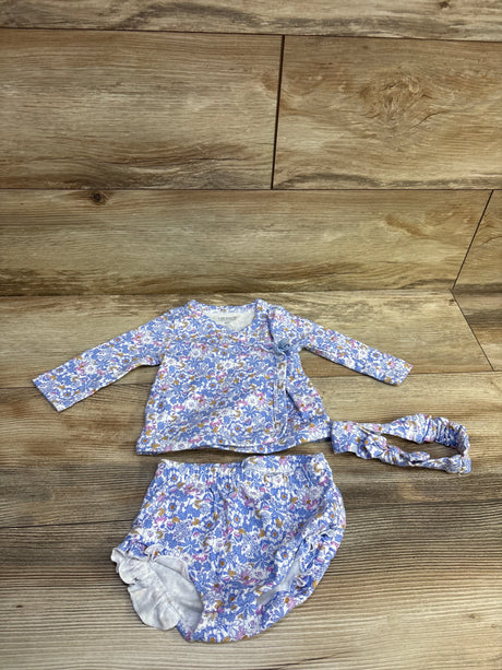 Top-down view of blue floral 3-piece kimono set with wrap top, bloomers, and headband on wood flooring