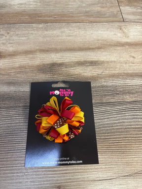 Colorful ribbon hair bow in autumn colors on Me 'n Mommy To Be card, wood background