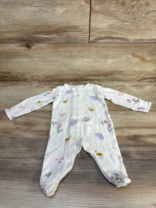 Flat lay of Carter's ivory footed sleeper with pastel bird and flower print snap front and long sleeves on wood plank floor