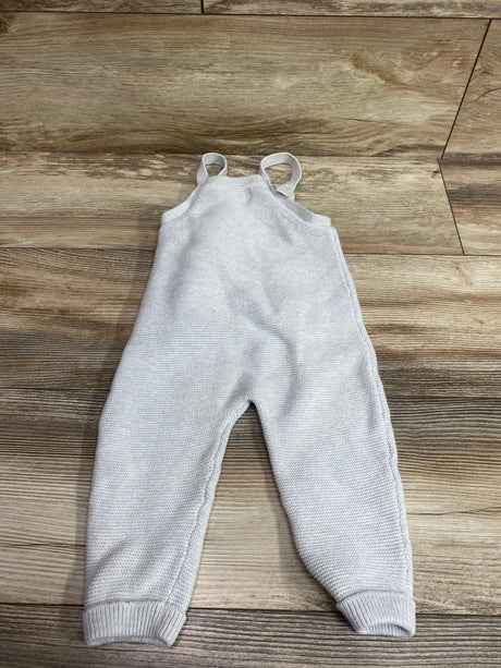 Front view of Little Planet gray knit overalls, size 18 months, showcasing shoulder straps and ribbed cuffs on a wood floor