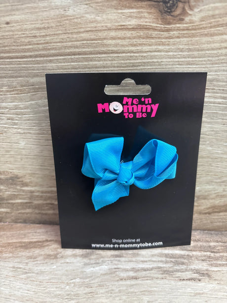 Front view of a blue solid hair bow showcasing its looped bow design on a black display card