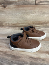 Side view of Carter's brown sneakers size 6C with faux-leather upper, hook-and-loop strap, white sole on wood background