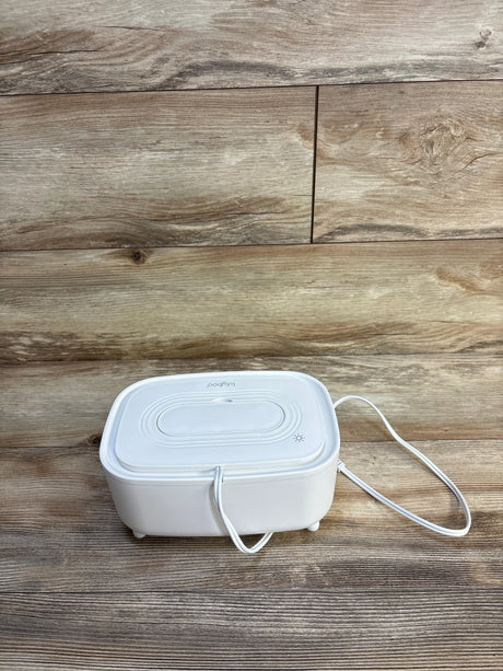 White Lulujo baby wipe warmer on wood floor, electric heated dispenser for infant care essentials