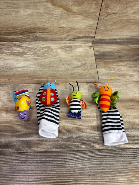 Top view of Lamaze Gardenbug Foot Finder and Wrist Rattle Set showcasing two striped foot finders and two insect rattles