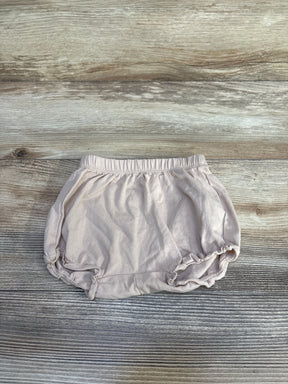 Flat lay of H&M beige cotton jersey baby bloomers showing elastic waistband and ruffled leg openings on wood background