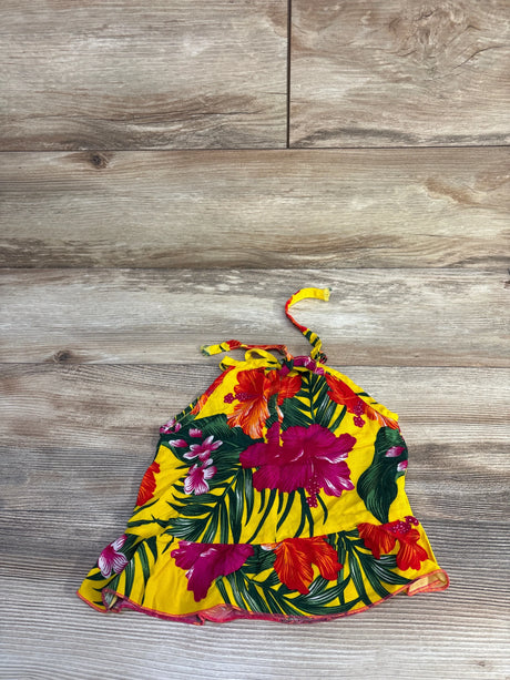 Flat lay of yellow Aloha baby halter sundress with red and magenta hibiscus print, ruffled hem, and halter tie on wood floor