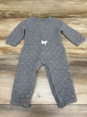 Front view of Carter’s gray quilted coverall with pink dots, white waist bow, and snap closures on wood background