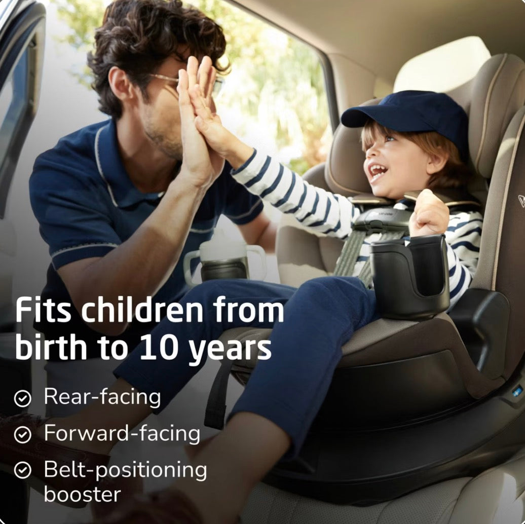 Child secured in a Maxi-Cosi Andi convertible car seat as a parent gives a high five; fits children from birth to 10 years
