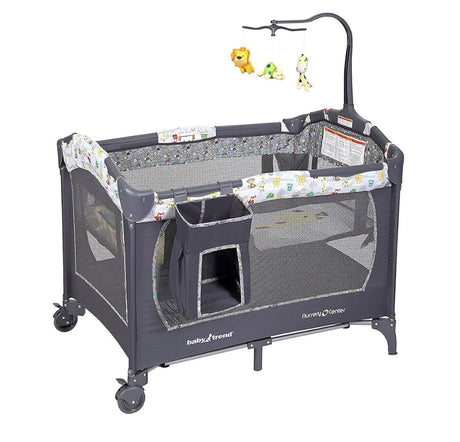 Three-quarter view of Baby Trend Nursery Center showcasing mesh sides and hanging toy mobile with white background