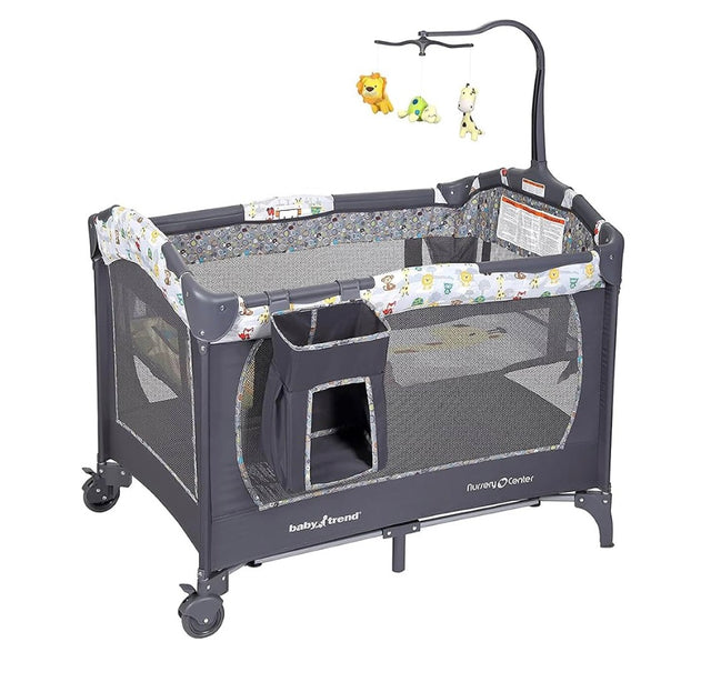 Three-quarter view of Baby Trend Nursery Center showcasing mesh sides and hanging toy mobile with white background