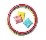 Colorful kids' bean bag toss game with red, yellow, and blue rings and patterned pillows for indoor play