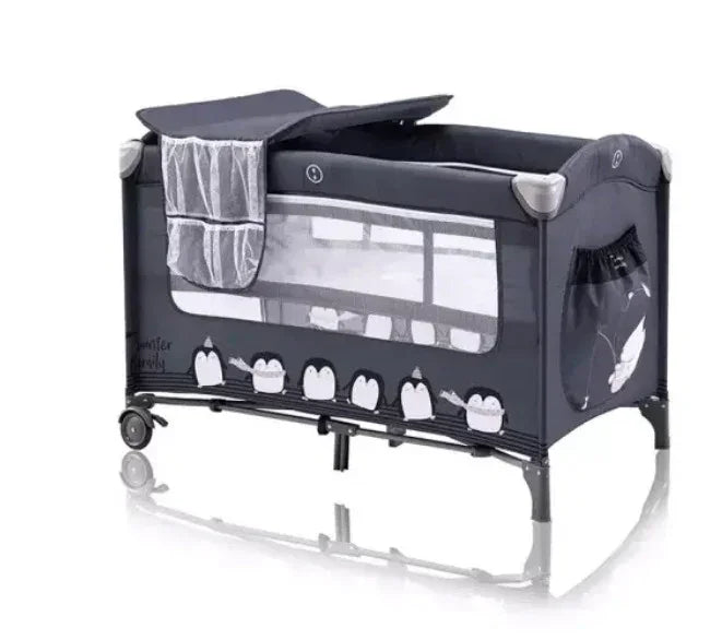 Portable baby playpen with penguin print, mesh sides, canopy, and wheels for easy mobility