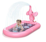 Front view of pink elephant inflatable splash pad pool showing arched sprinkler spray and toddler playing inside