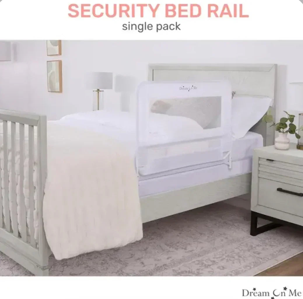 Side view of Dream on Me deluxe white bed rail showcasing mesh safety panel and folding metal frame on a staged bedroom bed