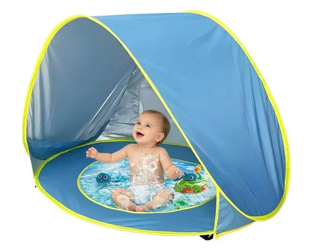 Baby playing in blue pop-up splash pool with shade tent, perfect for outdoor water fun and sun protection.