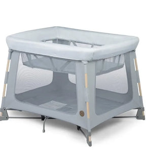 Angled front view of Maxi-Cosi Swift playard in Classic Slate showcasing mesh sides and padded top rail with white background
