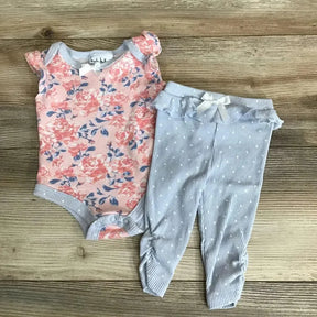 Flat lay of Nicole Miller 2-piece floral baby outfit: pink bodysuit and blue striped ruffle-waist leggings on wood