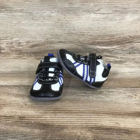 Front and side view of black and white Robeez leather baby sneakers with purple stripes and Velcro strap on wood background