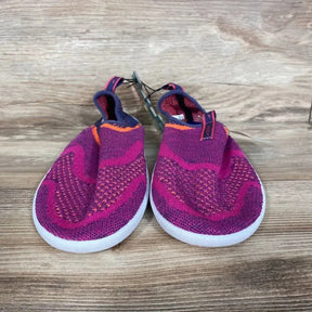 Front view of Speedo Junior Surf Strider water shoes in fuchsia knit with white soles on wooden background