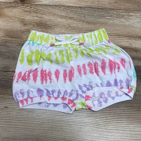 Flat lay of Okie Dokie tie-dye pull-on baby shorts, 3M, elastic drawstring waist and rolled cuffs on wood background