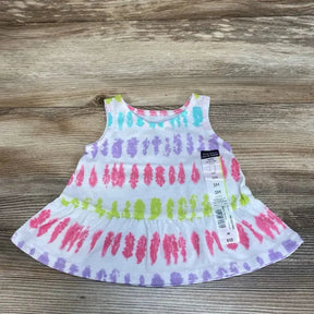 Flat lay of Okie Dokie tie-dye baby tank top size 3M showing colorful brushstroke stripes and flared hem on wood background