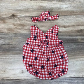 Flat lay of red and white gingham baby romper with navy stars and matching headband, size 3-6 months, on wood background