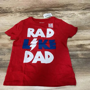 Front flat lay of red Old Navy toddler t-shirt with RAD LIKE DAD graphic and lightning bolt on wood background, 5T tag visible