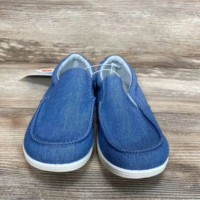 Front view of Cat & Jack Bergen slip-on toddler sneakers in blue denim showing elastic side panels and white rubber soles on wood background