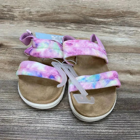Angled top of Cat & Jack Hazel kids' purple-pink tie-dye slip-on sandals with two padded straps and visible size 4Y tag on wood floor