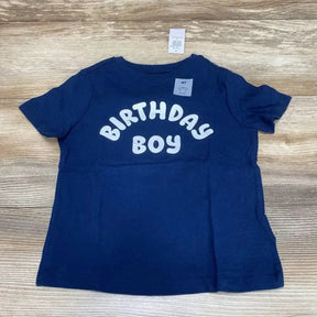 Flat lay of navy Old Navy toddler t-shirt (4T) showcasing white BIRTHDAY BOY text on the front with light wood background