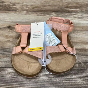 Top view of blush Cat & Jack footbed sandals showing contoured footbed, adjustable straps and price tag on wood background