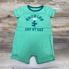 Front flat-lay of green Cat & Jack shortie romper (3-6m) showing Growing Day by Day flower graphic, snap crotch on wood floor