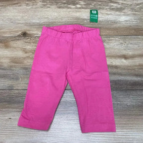 Flat lay of BabyGap solid pink leggings size 12 to 18 months showing elastic waistband and straight legs on wood background