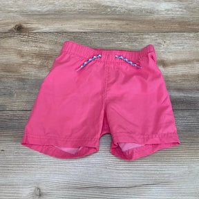 Front view of pink Old Navy toddler swim shorts (12-18m) showing elastic waistband and braided drawstring on wood floor