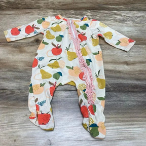 Flat lay of Mudpie fruit ruffle footed sleeper 0-3M with diagonal pink ruffle zipper and fruit print on wood background