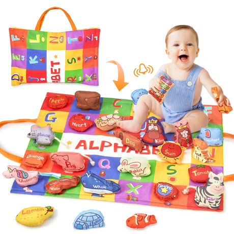 Baby in blue romper playing on colorful alphabet mat with matching soft animal and object toys
