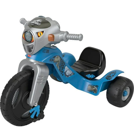 Three-quarter view of Fisher-Price Velociraptor tricycle with dinosaur-head handlebars, blue body and black seat on white background