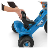 Close-up rear view of Fisher-Price Jurassic World Velociraptor tricycle showcasing adjustable black high-back seat and blue frame on white background