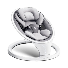 Three-quarter view of Munchkin baby swing with gray plush seat, padded head support, safety harness, and white ring base