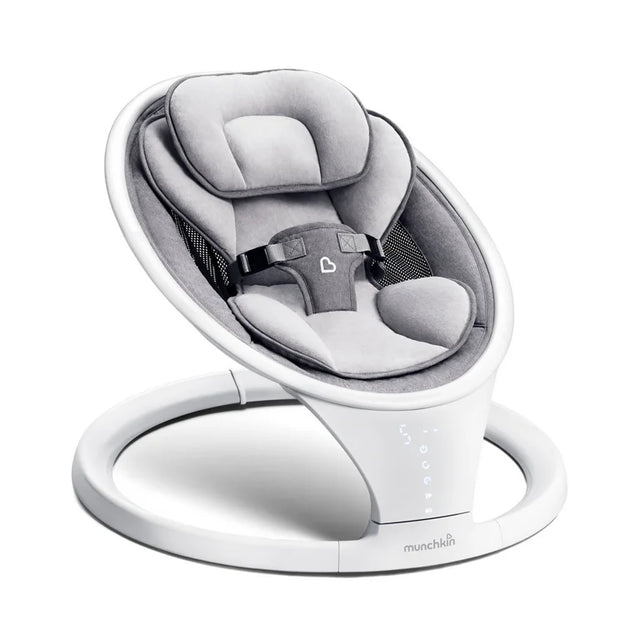 Three-quarter view of Munchkin baby swing with gray plush seat, padded head support, safety harness, and white ring base
