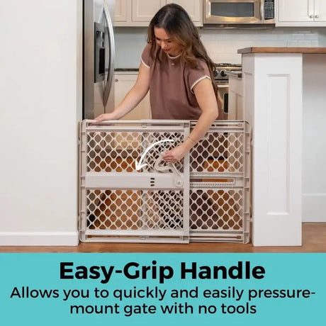 Front view of Toddleroo Supergate Ergo Classic Gate showcasing its easy-grip handle in a kitchen doorway