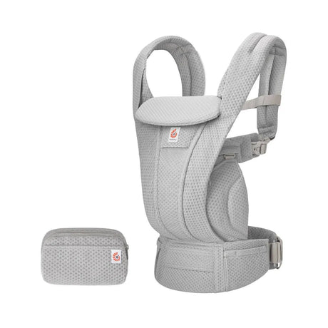 Three quarter view of Ergobaby Omni Deluxe Mesh Baby Carrier in Pearl Grey with matching pouch on a white background