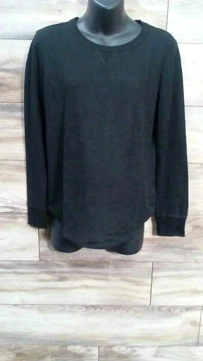 Front view of Gap maternity black waffle-knit long-sleeve T-shirt size M with crew neck and curved hem on wood background