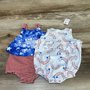Front flat lay of Cat & Jack baby rainbow romper with white rainbow-and-star print, chest ruffle and snap crotch on wood background