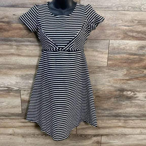 Front view of Jessica Simpson black-and-white striped waist-tie dress with short sleeves and flared skirt on wood background