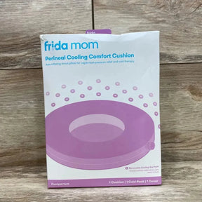 Front view of Frida Mom Perineal Cooling Comfort Cushion box showing purple donut image and headline on wood background