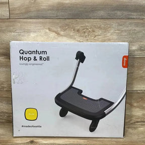 Front of boxed Diono Quantum Hop & Roll buggy board showing product image, large headline and yellow color swatch on wood floor