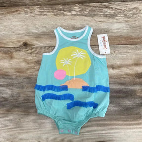 Front view of Cat & Jack beach romper in turquoise with palm tree and sun applique, blue ruffle waves, snap crotch on wood