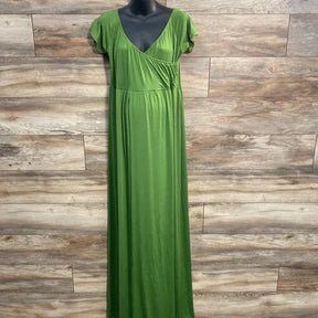 Front of green maxi dress with surplice V-neck, empire waist and cap sleeves on mannequin against wood plank backdrop